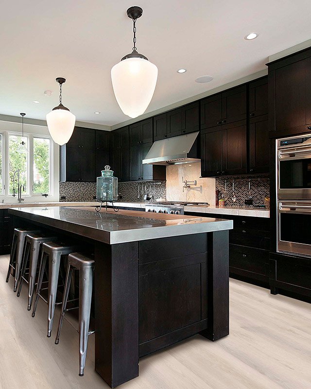 Kitchen in luxury home with dark wood cabinetry